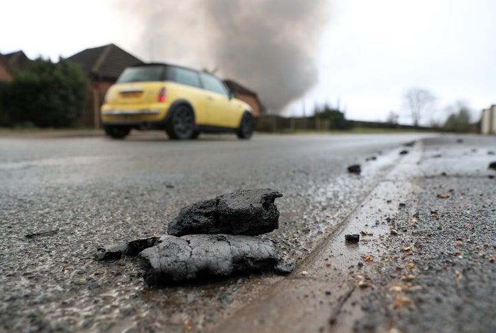 Debris from the Ocado robotic warehouse fire in Andover, litter the road and footpaths of Picket Piece in Hampshire.