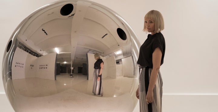 Gretchen (Toni Collette) alongside a hit artwork, "The Sphere," in "Velvet Buzzsaw."