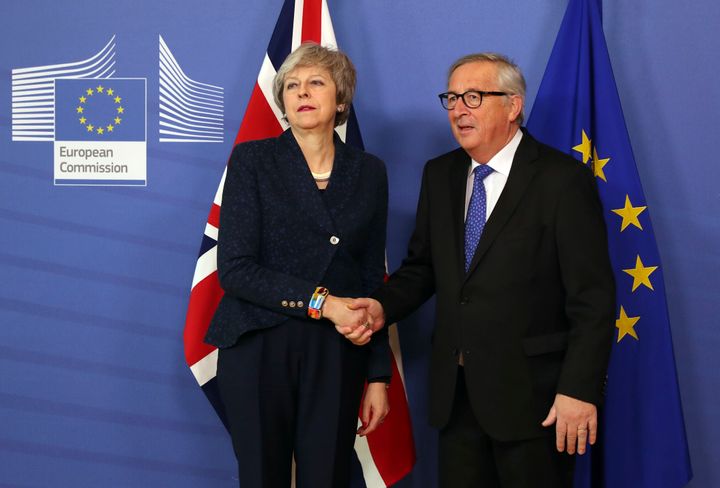 Theresa May in a frosty photo call with Jean-Claude Juncker