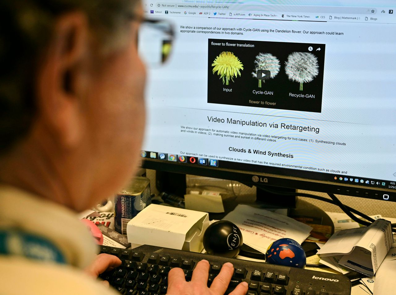 An AFP journalist views an example of a 'deepfake' video manipulated using artificial intelligence, by Carnegie Mellon University researchers, from his desk in Washington, DC January 25, 2019. - Some deepfakes may be harmless but others may be used for nefarious purposes. 'Deepfake' videos that manipulate reality are becoming more sophisticated and realistic as a result of advances in artificial intelligence, creating a potential for new kinds of misinformation with devastating consequences. 
