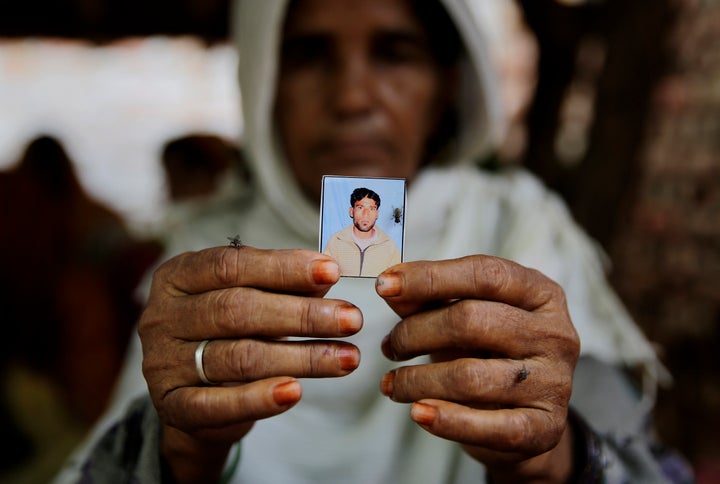 In this file photo, Kareeman Bano holds a photograph of her son-in-law Rakbar Khan who died after being thrashed by a mob in June 2018 on suspicion of cattle smuggling in Alwar, Rajasthan.