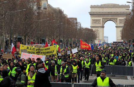 Protesters wearing yellow vests take part in a demonstration.