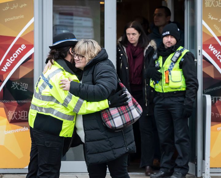 Lisa Squire, the mother of missing student Libby Squire, hugs a police officer on leaving a service at Hull Community Church. 