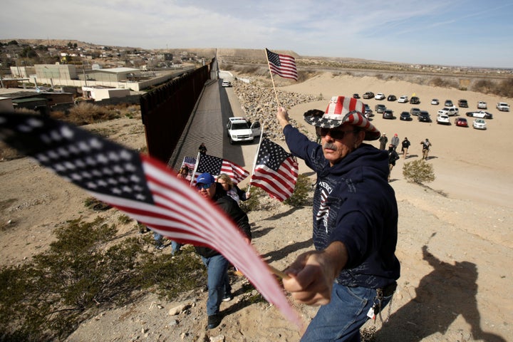 Waving U.S. flags, the protesters chanted, "Build a wall."