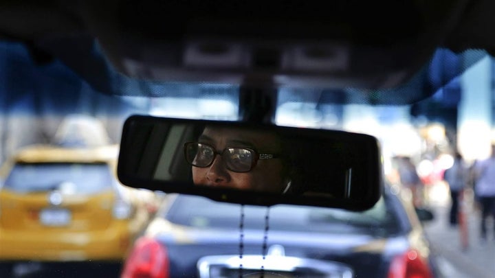 <p>Dinorah De Cruz drives through Manhattan on her way to the Queens office of SheRide, a car service by women for women. California has moved to prohibit companies from considering gender in setting automobile insurance rates.</p>