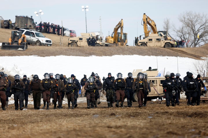 Law enforcement officers advance into the main opposition camp against the Dakota Access Pipeline near Cannon Ball, North Dakota, on Feb. 23, 2017.