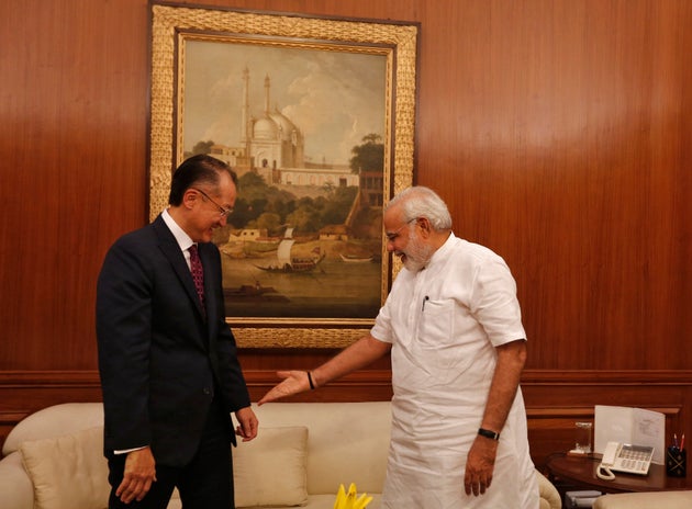 Prime Minister Narendra Modi (R) gestures to the World Bank President Jim Yong Kim (L) to sit while meeting...