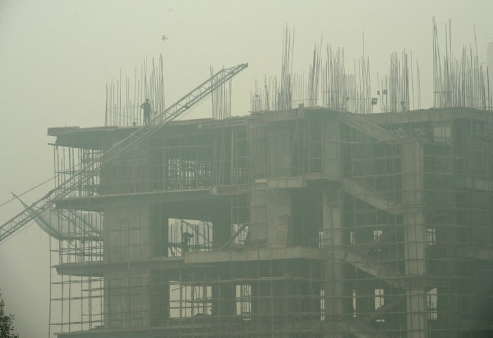 File photo of labourers working in an under-construction building as smog covers the capital's skyline in New Delhi on November 2, 2016. A scientific research paper published in Lancet in December 2018, and backed by the Modi government’s health ministry, said one in eight deaths in India could be caused due to air pollution.