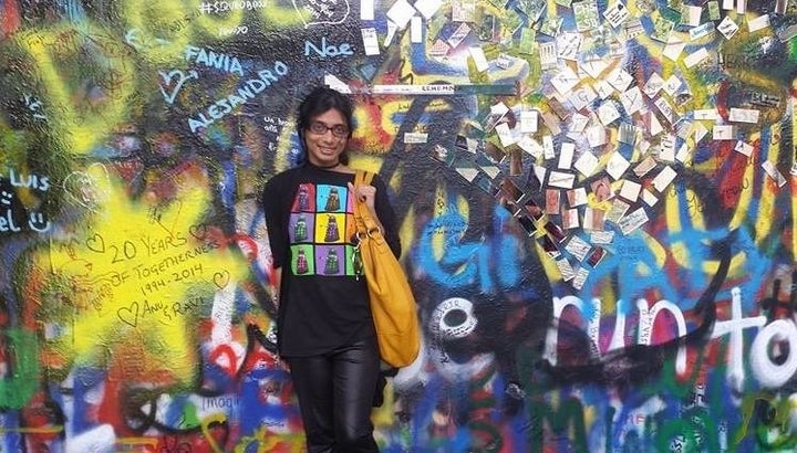Senaratna in front of the famous John Lennon Wall in Prague.