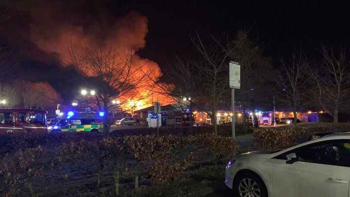 Images showed flames and smoke billowing from the building’s roof, part of which appeared to have fallen in. 
