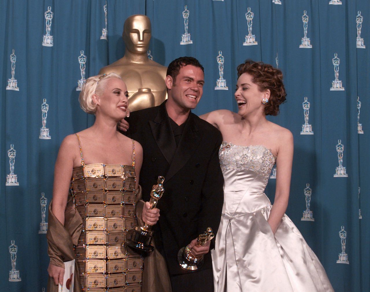 Lizzy Gardiner (left) and Tim Chappel, who won Best Costume Design in 1995, with presenter Sharon Stone.