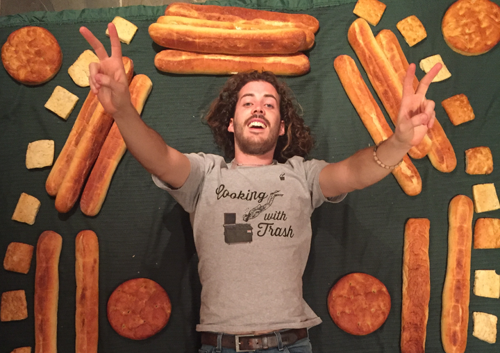 Cameron Macleish is surrounded by a haul of fresh bread after a dumpster diving session.