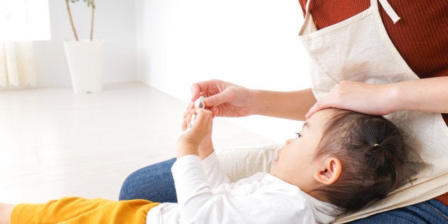 Nursery teacher care child having a cold