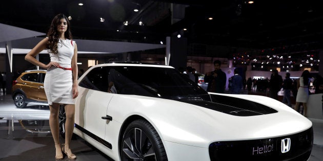 A model poses alongside Honda Sports EV Concept car at the India Auto Show 2018 in Greater Noida, India February 8, 2018. REUTERS/Saumya Khandelwal