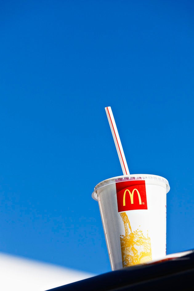 "Cape Town, South Africa - June 21, 2011: A McDonald's soft drink container sits on the roof of a car outside a branch of the multinational fast-food chain in Cape Town's southern suburbs."