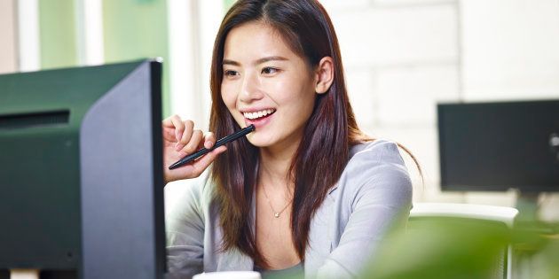 young asian businesswoman working in office using computer.