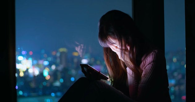 woman use phone and feel depression at night