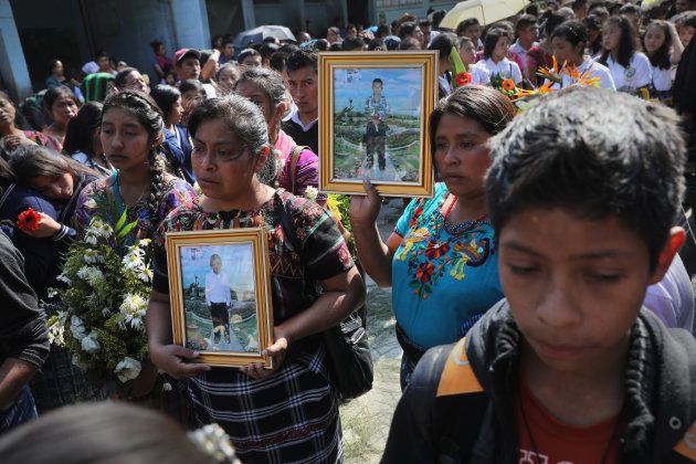 SAN JUAN SACATEPEQUEZ, GUATEMALA - FEBRUARY 14: Mothers carry portraits of their sons who were kidnapped and killed on February 14, 2017 in San Juan Sacatepequez, Guatemala. More than 2,000 people walked in a funeral procession for Carlos Daniel Xiqin, 10, and Oscar Armando Top Cotzajay, 11, who were reported abducted walking to school Friday morning. Residents found the boys stuffed in sacks over the weekend, with the boys' throats slashed and hands and feet bound. Neighbors reported a ransom demand was made. Such crimes have driven emigration from Guatemala to the United States, as families seek refuge from the violence. (Photo by John Moore/Getty Images)