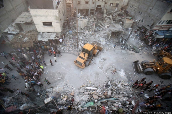 A digger removes the rubble of the Ghanam family home after it was targeted in an Israeli air raid on Rafah, in the southern Gaza strip, on July 11, 2014. (SAID KHATIB/AFP/Getty Images)