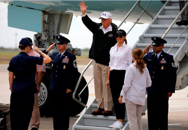 U.S. President Donald Trump (C) waves next to first lady Melania Trump upon arrival prior to receiving a briefing on Tropical Storm Harvey relief efforts in Corpus Christi, Texas, U.S., August 29, 2017. REUTERS/Carlos Barria
