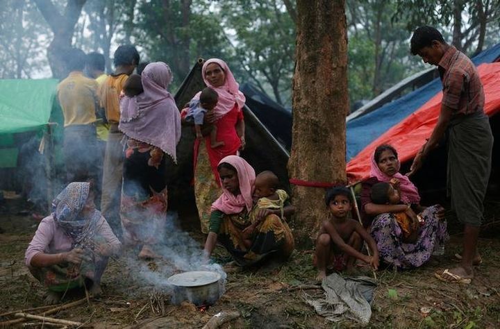 Rohingya refugees go about their day outside their temporary shelters along a road in Kutupalong, Bangladesh, September 9, 2017. © 2017 Danish Siddiqui/Reuters