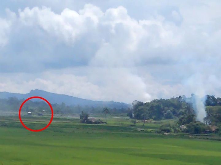 A screen grab of a video shows two dark-colored Burmese military trucks within several hundred meters of a burning village. © 2017 Private