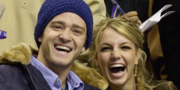 FILE - In this Feb. 10, 2002, file photo, Justin Timberlake and Britney Spears wave to the crowd prior to the start of the 2002 NBA All-Star game in Philadelphia. Timberlake told E! News on Sept. 13, 2016, that he's open to collaborating with Spears. Spears mentioned Timberlake last month in answering a question about who she would like to work with one day. (AP Photo/Chris Gardner, File)