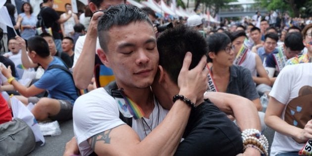 Same-sex activists hug outside the parliament in Taipei on May 24, 2017 as they celebrate the landmark decision paving the way for the island to become the first place in Asia to legalise gay marriage.Crowds of pro-gay marriage supporters in Taiwan on May 24 cheered, hugged and wept as a top court ruled in favour of same-sex unions. / AFP PHOTO / SAM YEH (Photo credit should read SAM YEH/AFP/Getty Images)