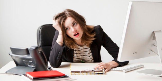 Studio shot of young woman working in office being under emotional stress