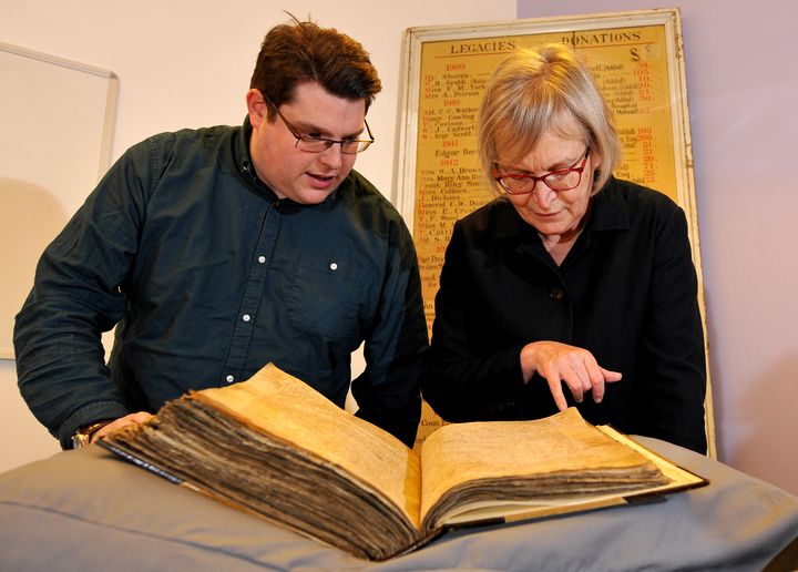 Gary Brannan, an archivist, and Sarah Rees Jones, director of the University of York's Centre for Medieval Studies, examine one of the registers of the archbishops of York.