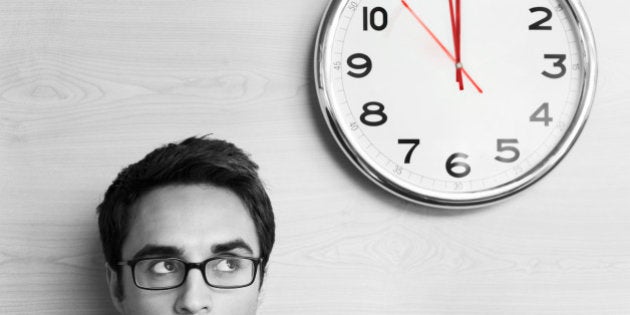 Anxious Businessman Looking at Office Clock