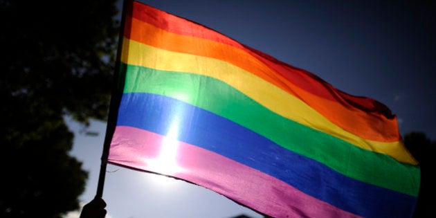 A participants holds a rainbow flag during the gay and lesbian pride parade in the center of Madrid on June 30, 2012. AFP PHOTO/Pedro ARMESTRE (Photo credit should read PEDRO ARMESTRE/AFP/GettyImages)