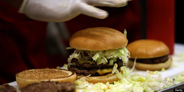 An employee prepares burgers at a Fatburger outlet in Karachi, Pakistan, on Saturday, Jan. 5, 2013. Fatburger opened its first outlet in Pakistan to the public on Jan. 5. Photographer: Asim Hafeez/Bloomberg via Getty Images