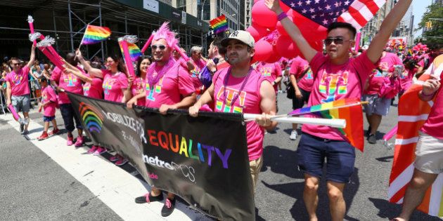 IMAGE DISTRIBUTED FOR T-MOBILE - T-Mobile employees sprinkle some 'Magenta Magic' as they celebrate equal rights for the LGBT community during the New York City Pride March, for which T-Mobile is the presenting sponsor, Sunday, June 26, 2016. (Stuart Ramson/AP Images for T-Mobile)