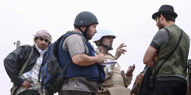 MISRATA, LIBYA - JUNE 02: In this handout image made available by the photographer American journalist Steven Sotloff (Center with black helmet) talks to Libyan rebels on the Al Dafniya front line, 25 km west of Misrata on June 02, 2011 in Misrata, Libya. Sotloff was kidnapped in August 2013 near Aleppo, Syria and was recently shown on a jihadist video in which fellow US journalist James Foley was executed. In the video the militant form the Islamic State (IS) threatens to kill Sotloff next if the US continues its aerial campaign against the insurgency. (Photo by Etienne de Malglaive via Getty Images)