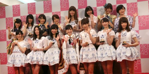 The top 15 members of Japanâs all-girl pop idol group AKB48, from top left in clockwise, Aya Shibata, Yui Yokoyama, Sakura Miyawaki, Minami Takahashi, Haruna Kojima, Akari Suda, Sae Miyazawa, Rina Ikoma, Haruka Shimazaki, Rena Matsui, Yuki Kashiwagi, Mayu Watanabe, Rina Sashihara, Jurina Matsui and Sayaka Yamamoto pose for photographers after the annual AKB48 popularity poll in Tokyo, Saturday, June 7, 2014. In the event, fans pick their favorites from the group members. (AP Photo/Eugene Hoshiko)
