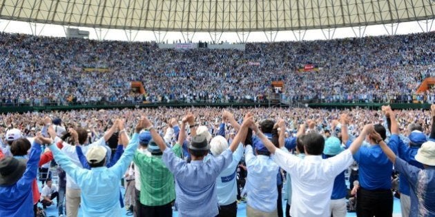 Some 35,000 protesters raise their hands during a rally to protest against a controversial US airbase in Naha in Japan's southern island of Okinawa on May 17, 2015. Futenma US airbase has become emblematic of that ill-will since Washington announced plans to move it in 1996, hoping to ease tensions with the host community after the gang-rape of a schoolgirl by servicemen. But locals have blocked the move to relocate the base, insisting the facility should go off-island instead, harming relations between Tokyo and Okinawa -- a once independent kingdom that was annexed by Japan in the 19th century. JAPAN OUT -- AFP PHOTO / JIJI PRESS (Photo credit should read JIJI PRESS/AFP/Getty Images)