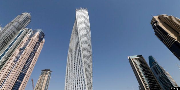 The Cayan tower (C), the world's tallest twisted tower stands at Dubai's Marina on June 11, 2013 in the United Arab Emirates, UAE. AFP PHOTO/KARIM SAHIB (Photo credit should read KARIM SAHIB/AFP/Getty Images)