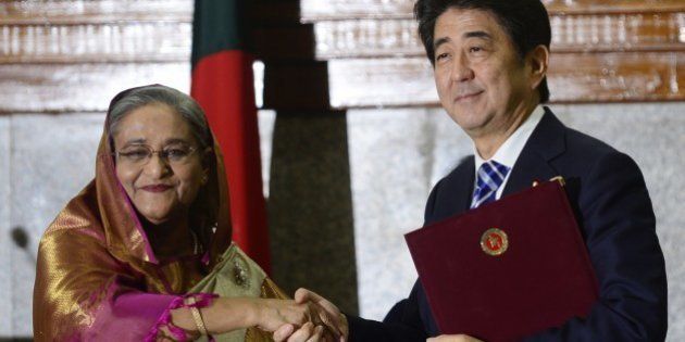 Japanese Prime Minister Shinzo Abe (R) and Bangladesh Prime Minister Sheikh Hasina (L) pose for a photo after a signing ceremony at the Prime Minister's office in Dhaka on September 6, 2014. Japanese premier Shinzo Abe secured Dhaka's support for Tokyo's bid for a non-permanent seat in the UN Security Council as he started a three-day visit to Bangladesh and Sri Lanka aimed at offsetting China's mounting influence in South Asia. AFP PHOTO/ Munir uz ZAMAN (Photo credit should read MUNIR UZ ZAMAN/AFP/Getty Images)