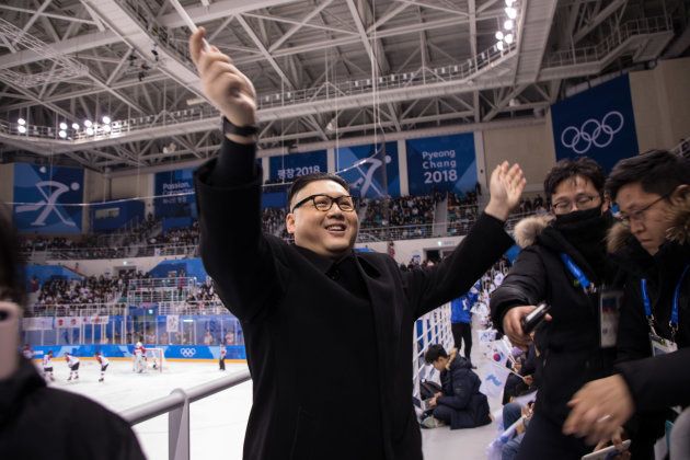 A man impersonating North Korean leader Kim Jong Un waves a unified Korean flag before North Korean cheerleaders attending the Unified Korean ice hockey game against Japan during the Pyeongchang 2018 Winter Olympic Games at the Kwandong Hockey Centre in Gangneung on February 14, 2018. / AFP PHOTO / YELIM LEE (Photo credit should read YELIM LEE/AFP/Getty Images)