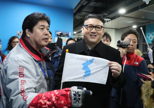 Ice Hockey ? Pyeongchang 2018 Winter Olympics ? Women Preliminary Round Match - Korea v Japan - Kwandong Hockey Centre, Gangneung, South Korea ? February 14, 2018 - Kim Jong-un impersonator holds a Korean unification flag. REUTERS/Lucy Nicholson