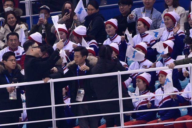 A Kim Jong Un impersonator cheers in front of North Korean cheerleaders during the final period of the women's preliminary round ice hockey match between Unified Korea and Japan during the Pyeongchang 2018 Winter Olympic Games at the Kwandong Hockey Centre in Gangneung, South Korea on February 14, 2018. / AFP PHOTO / Brendan Smialowski (Photo credit should read BRENDAN SMIALOWSKI/AFP/Getty Images)