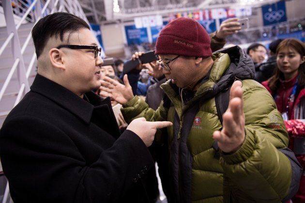 A Kim Jong Un impersonator is confronted during the final period of the women's preliminary round ice hockey match between Unified Korea and Japan during the Pyeongchang 2018 Winter Olympic Games at the Kwandong Hockey Centre in Gangneung, South Korea on February 14, 2018. / AFP PHOTO / Brendan Smialowski (Photo credit should read BRENDAN SMIALOWSKI/AFP/Getty Images)