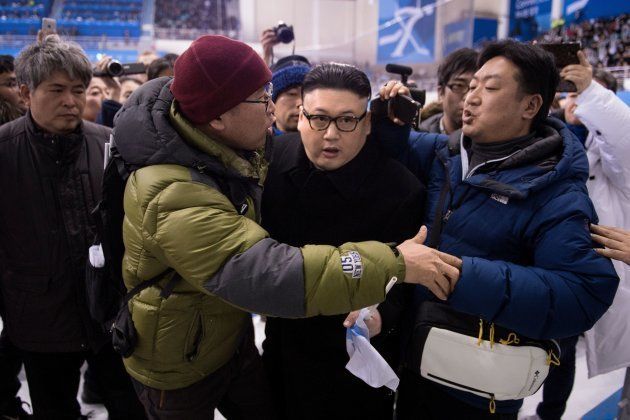 TOPSHOT - A Kim Jong Un impersonator is forced out in the final period of the women's preliminary round ice hockey match between Japan and the Unified Korean team during the Pyeongchang 2018 Winter Olympic Games at the Kwandong Hockey Centre in Gangneung on February 14, 2018. / AFP PHOTO / Brendan Smialowski (Photo credit should read BRENDAN SMIALOWSKI/AFP/Getty Images)