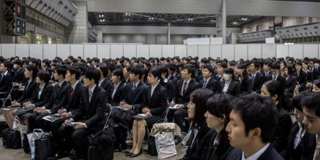TOKYO, JAPAN - MARCH 08: (EDITORIAL USE ONLY) College students listen to a company information session at the Mynavi Shushoku MEGA EXPO at the Tokyo Big Sight on March 8, 2015 in Tokyo, Japan. 70,000 job-seeking students are expected to attend the two-day career fair with 1230 companies participating. Under new rules starting this academic year, companies are allowed to conduct recruiting activities from March 1 onward, rather than December so that third-year university students can concentrate on their studies. (Photo by Chris McGrath/Getty Images)