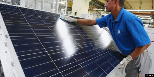 FRANKFURT (ODER), GERMANY - AUGUST 19: A worker cleans a finished solar energy panel at a production plant of German solar panels maker Conergy on August 19, 2009 in Frankfurt (Oder), Germany. Conergy is expanding its production capacity in order to meet increasing worldwide demand for solar energy. (Photo by Sean Gallup/Getty Images)