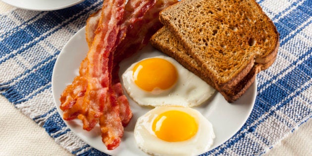 Organic Sunnyside up Egg with toast and bacon for breakfast