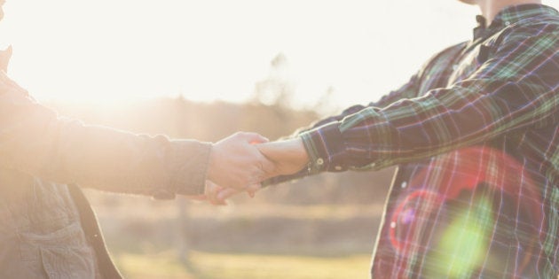 Close up of Gay couple holding hands outdoor