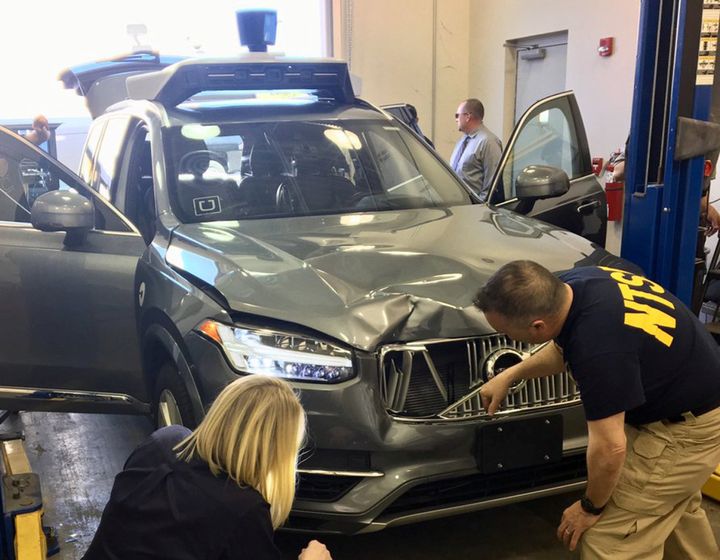 National Transportation Safety Board (NTSB) investigators examine a self-driving Uber vehicle involved in a fatal accident in Tempe, Arizona, U.S., March 20, 2018. A women was struck and killed by the vehicle on March 18, 2018. National Transportation Safety Board/Handout via REUTERS ATTENTION EDITORS - THIS IMAGE WAS PROVIDED BY A THIRD PARTY.