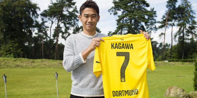 DORTMUND, GERMANY - AUGUST 31: Shinji Kagawa of Dortmund signs his new Borussia Dortmund contract at Dortmund on August 31, 2014 in Dortmund, Germany. (Photo by Alexandre Simoes/Borussia Dortmund/Getty Images)